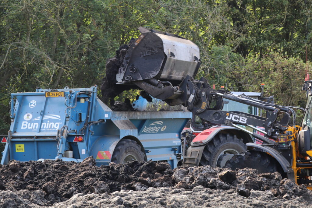 A JCB 419S supports the spreader team and takes just four buckets to fill each machine